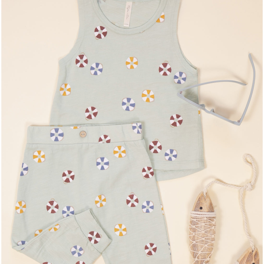 Children's sleeveless top and pants set with colorful pattern on a grey background